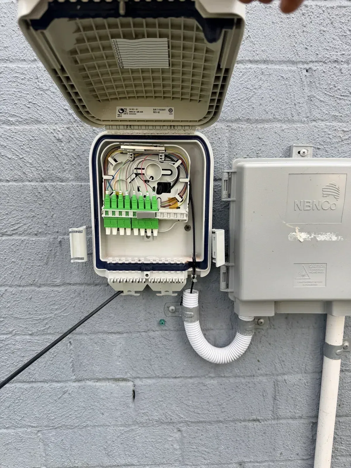 Netlink technician performing fibre splicing in an NBN pit near Newcastle