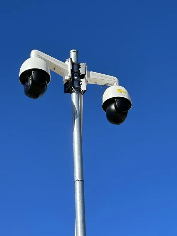 Netlink twin PTZ dome CCTV cameras pole-mounted for wide-area surveillance at a Hunter Valley commercial site — Hikvision PTZ install